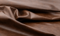 Close up of saddle brown distress upholstery leather