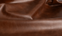 Close up of saddle brown distress upholstery leather