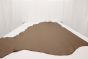 Warm mocha genuine leather cowhide laying flat on a table