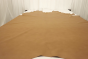 Picture of warm gold semi aniline natural grain leather for upholstery displayed on a table