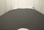 Picture of warm dark grey pebbled leather for upholstery displayed on a table