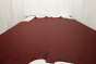 Picture of warm deep red nappa-like smooth upholstery leather displayed on a table