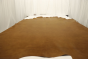 Picture of golden amaretto full grain leather for upholstery displayed on a table