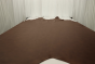 Picture of dark brown with red/brown undertones natural mill pebble leather for upholstery displayed on a table