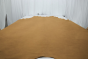 Picture of light mocha aniline leather for upholstery displayed on a table
