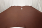 Picture of Swing Time, dark brandy semi-aniline leather hide for upholstery displayed on a table