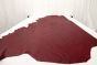 Deep red colored top grain leather laying flat on a table