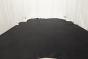 Multi-tone smoky black genuine leather cowhide laying flat on a table
