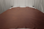 Picture of Whiskey Beat, rich warm brown semi-aniline leather hide for upholstery displayed on a table