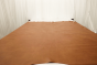Picture of Hangin in Harlem, warm brown semi-aniline leather hide for upholstery displayed on a table