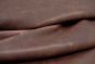 Close up picture of dark red distressed leather for upholstery