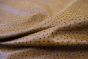 Close up picture of Summer Ostrich, a golden brown embossed leather with dark brown tips.