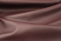 Close up picture of dark purple leather with pebble grain upholstery leather