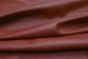 Close up picture of ruby red smooth grain leather for upholstery