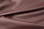 Close up picture of dark purple leather with pebble grain upholstery leather