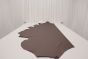 Chocolate brown colored leather material laying flat on a table 