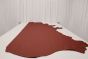 Ruby red colored leather material laying flat on a table 