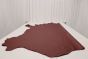 Burgundy colored leather material laying flat on a table 