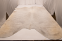 Picture of white with darker accents silky soft leather for upholstery displayed on a table
