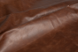 Close up of saddle brown distress upholstery leather