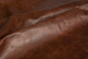 Close up of saddle brown distress upholstery leather