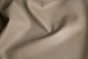 Close up of ivory taupe natural grain upholstery leather