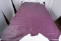 Picture of a dark purple with light undertones pull up leather for upholstery displayed on a table