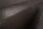 Close up of dark espresso brown distress upholstery leather