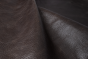 Close up of dark espresso brown distress upholstery leather