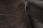 Close up of dark espresso brown distress upholstery leather
