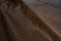 Close up of dark brown with light undertones pull up upholstery leather