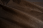 Close up of dark brown with light undertones pull up upholstery leather