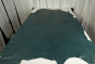 Picture of teal aniline dyed upholstery leather displayed on a table