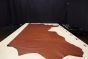 Brandy colored Italian leather cowhide laying flat on a table 
