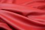 Close up picture of bright red smooth grain leather for upholstery