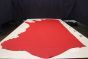 Bright red colored leather material laying flat on a table 
