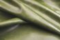 Close up picture of green aniline leather for upholstery