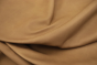 Close up of a light mocha color pull up upholstery leather 