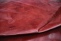 Close up of rich bright red full grain upholstery leather