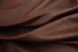 Close up of rich saddle brown semi-aniline upholstery leather