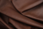 Close up of rich saddle brown semi-aniline upholstery leather