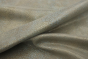 Close up of metallic gold with teal accents embossed suede-like upholstery leather