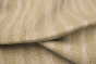 Close up of ivory with tan undertones embossed upholstery leather