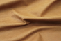Picture of draping Golden Moccasin, golden brown cowhide leather for upholstery and furniture.
