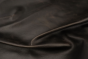 Close up of espresso brown full grain distressed upholstery leather