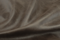 Close up of dark brown distressed upholstery leather