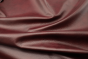 Closeup picture of Wine Bar soft, dark burgundy colored upholstery leather for furniture