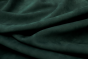 Closeup picture of soft deep green nubuck showing the texture of leather