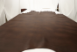 Picture of multi tone tobacco brown semi-aniline upholstery leather displayed on a table 