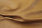 Close up picture of warm gold full grain upholstery leather